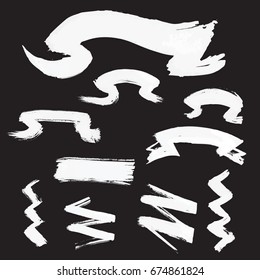 Hand drawn ribbons created by dry brush. Grunge style set on the black background. Vector clip art elements for expressive design.