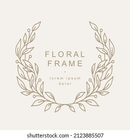 Hand drawn round floral frame with a branch and leaves, laurel wreath. Elegant leaf logo template. Decorative elements for design. Vector illustration  isolated on background