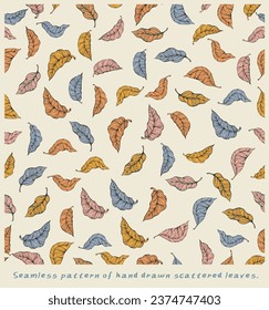 Hand drawn scattered leaves in a continuous seamless pattern