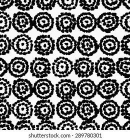 Hand drawn seamless circle shapes pattern. Black brush strokes repeating texture on white background.