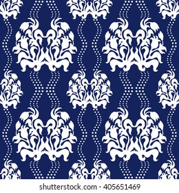 Hand drawn seamless damask pattern with baroque blooming tulips and wavy dotted lines. Art Deco wallpaper collection. White on dark blue.