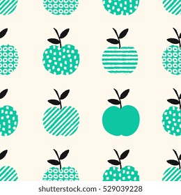 Hand drawn seamless pattern with apples in green, black and cream.