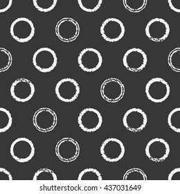 Hand drawn seamless pattern with black grunge rings, circle. Wrapping paper. Abstract vector background. Brush strokes rings. Casual texture. Doodle. Dry brush. Rough edges ink illustration.