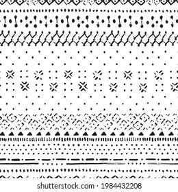 Hand drawn seamless pattern in bohemian style with old texture effect. Black and white boho stripes pattern with dots and brush strokes.