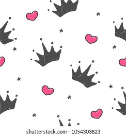 Hand drawn seamless pattern with doodle crowns. Cute baby and little princess design. Children's room wallpaper and clothes texture.