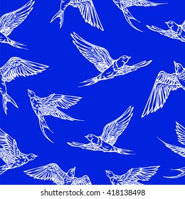 Hand drawn seamless pattern with flying swallows. Endless blue pattern with birds.