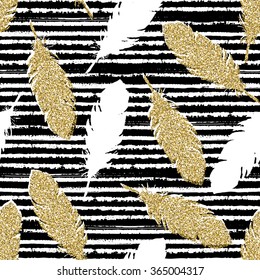 Hand drawn seamless pattern. Gold glitter feathers on striped background