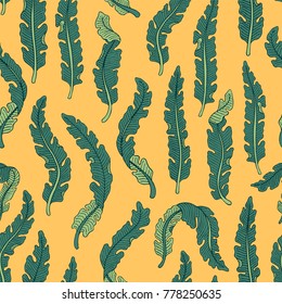 Hand drawn seamless pattern with green tropical banana leaves on yellow background. Hand drawn jungle texture. Ornate vector background for print, interior, wallpaper, fabrics