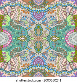 Hand drawn seamless pattern, repeating texture for textile fabric print. Colorful doodle background with geometric and floral elements. Tribal ethnic mandala ornament for scarf, shawl, hijab design