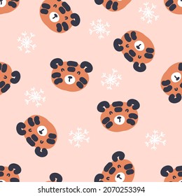 Hand drawn seamless pattern with tiger faces and snowflakes. Perfect for T-shirt, textile and print. Doodle vector illustration for decor and design.
