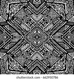 Hand drawn seamless pattern with tribal aztec motives. Black and white abstract wallpaper in boho style.