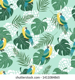 Hand drawn seamless pattern with tropical birds and leaves on blue background. Vector flat illustration of parrots .