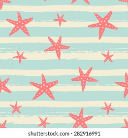 Hand drawn seamless repeat pattern with starfish in red on blue and cream striped brush strokes background.