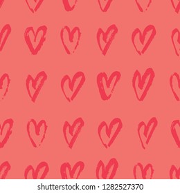 Hand drawn seamless repeating pattern with hearts in red on coral orange background. Cute and trendy romantic design poster, wrapping paper, Valentine card design.