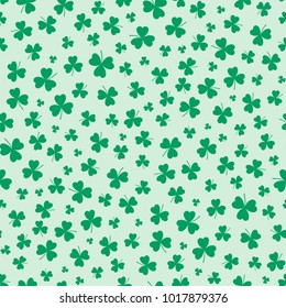 Hand drawn seamless vector pattern with shamrocks, on a green background. Design concept for Saint Patrick's day celebration, kids textile print, wallpaper, wrapping paper.
