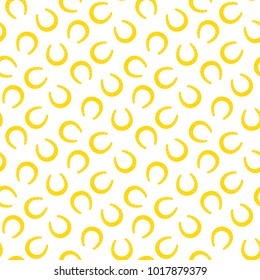 Hand drawn seamless vector pattern with horseshoes on a white background. Design concept for Saint Patrick's day celebration, kids textile print, wallpaper, wrapping paper.