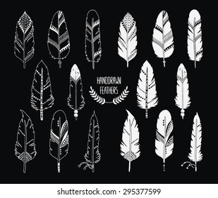 Hand drawn set of feathers and silhouette isolated on black background. Ink illustration with different indian feathers isolated on white background