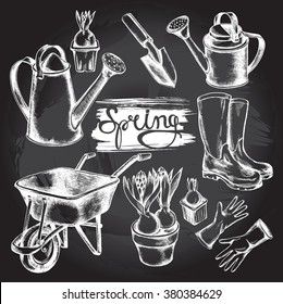 Hand drawn set of garden accessories: wheelbarrow, gloves, rubber boots, shovel, watering can and hyacinths. Vector illustration on blackboard.
