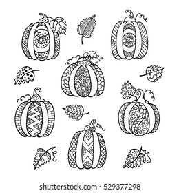 Hand drawn set of pumpkins for anti stress colouring page. Pattern for coloring book. Illustration in zentangle style. Black and white background.