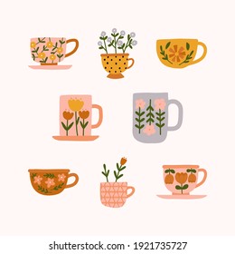 Hand drawn set of various floral trendy modern tea cups or mugs with different cute flowers ornaments in scandinavian style illustration. Crockery with handle for drink.