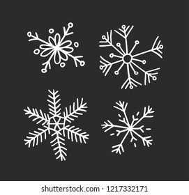 Hand drawn set of vintage snowflakes. White on black background. Abstract  doodle drawing snow. Vector retro art illustration