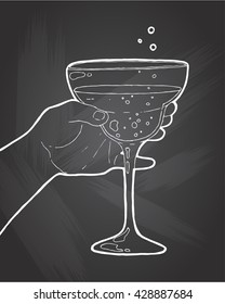 Hand drawn sketch ice alcoholic cocktail in a hand vintage . Vector illustration for coctail menu in chalkboard background. Vector illustration in sketch style.  Hand drawn design element