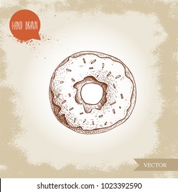Hand drawn sketch style donut with sprinkles. Bakery good top view with icing cream. Vintage sweet pastry vector illustration. Isolated on old background.