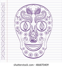 Hand drawn skull in doodle style on notebook page.