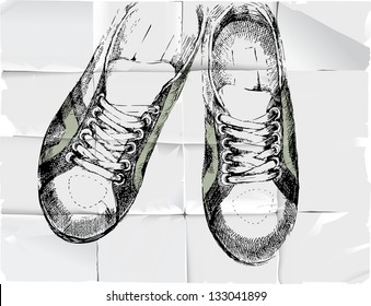 Hand drawn sneakers over crumpled paper background