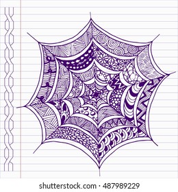 Hand drawn spider's web in doodle style on notebook page.