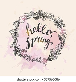 Hand drawn spring greeting card on grunge watercolor stained background.  Spring flowers with hyacinth and crocus, willow branches and leaves wreath. Hello spring hand lettering. 