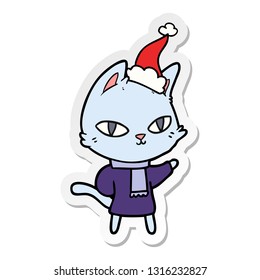 hand drawn sticker cartoon of a cat staring wearing santa hat