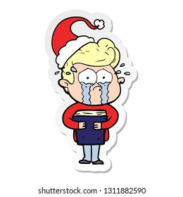 hand drawn sticker cartoon of a crying man holding book wearing santa hat