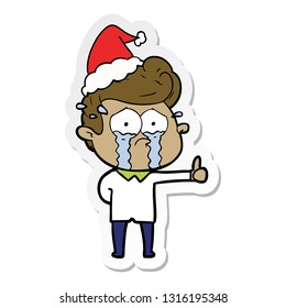 hand drawn sticker cartoon of a crying man wearing santa hat
