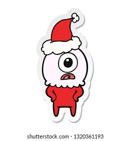 hand drawn sticker cartoon of a cyclops alien spaceman wearing santa hat