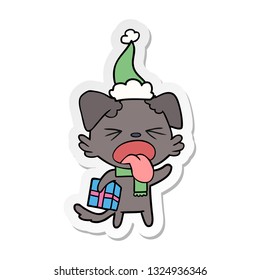 hand drawn sticker cartoon of a disgusted dog with christmas gift wearing santa hat