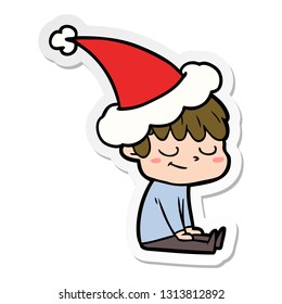hand drawn sticker cartoon of a happy boy wearing santa hat