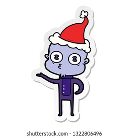 hand drawn sticker cartoon of a weird bald spaceman wearing santa hat