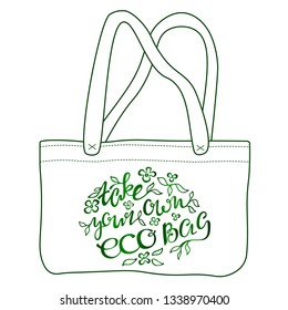 Hand drawn style canvas reusable eco bag with motivational inspirational phrase “Take your own eco bag”,  green leaves and flowers print. Handwritten calligraphy text, modern lettering, doodle style