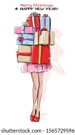 Hand drawn stylish woman with new year gifts. Girl in red shoes holding colorful gift boxes. Sketch. Vector illustration.