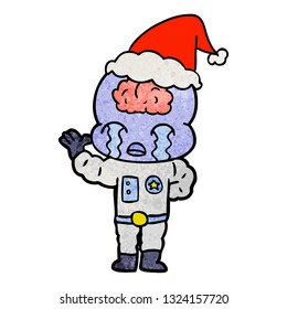 hand drawn textured cartoon of a big brain alien crying wearing santa hat