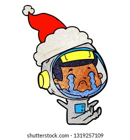 hand drawn textured cartoon of a crying astronaut wearing santa hat