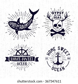 Hand drawn textured vintage badges set with shark, pirate skull, steering wheel, anchor, and inspirational lettering.