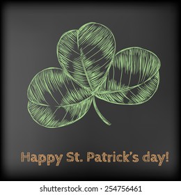 Hand- drawn three leaf clover on chalkboard background. St.Patrick's day design.