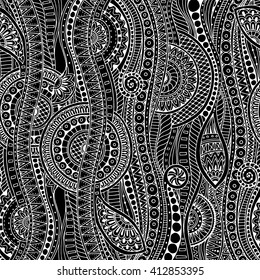 Hand drawn tribal ethnic pattern. Doodle black and white background with doodles, flowers and mandalas. Geometric mosaic pattern. Can be used for wallpaper, pattern fills, covers and books