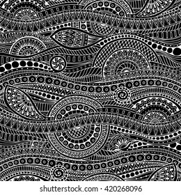 Hand drawn tribal ethnic pattern. Doodle black and white background with doodles, flowers and mandalas. Geometric mosaic pattern. Ethnic pattern can be used for wallpaper, pattern fills, covers, books