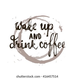 Hand drawn typography lettering phrase Wake up and drink coffee isolated on the white background with stains of coffee. Modern calligraphy for typography greeting and invitation card or t-shirt print