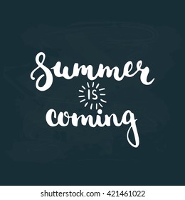 Hand drawn typography lettering phrase Summer is coming isolated on the dark blue chalkboard background. Modern calligraphy for typography greeting and invitation card or t-shirt print