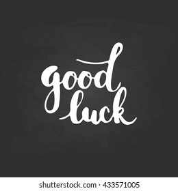 Hand drawn typography lettering phrase Good Luck isolated on the black chalkboard background. Fun calligraphy for typography greeting and invitation card or t-shirt print design.