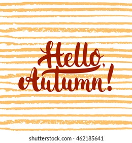 Hand drawn typography lettering phrase Hello, Autumn! on the orange striped background. Fun brush ink calligraphy inscription for photo overlays, greeting and invitation card or t-shirt print design.